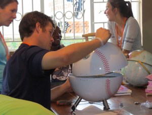 After unpacking donations, Kershaw assembles a baseball BBQ for the home.