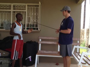 Kershaw shows orphanage resident Peter how to stretch before pitching.